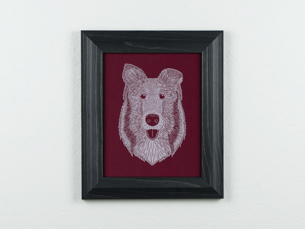 Collie on maroon paper